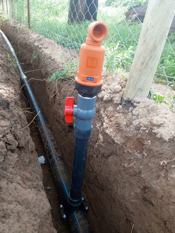 Buried mainline and riser in an open trench